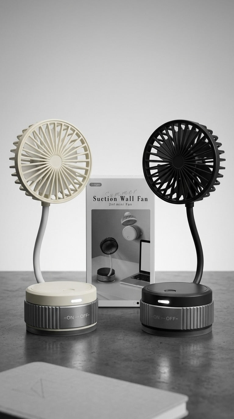 Two suction wall fans, one white and one black, on a gray surface with a neutral background.
