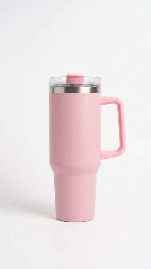Pink travel mug with a handle on a white background